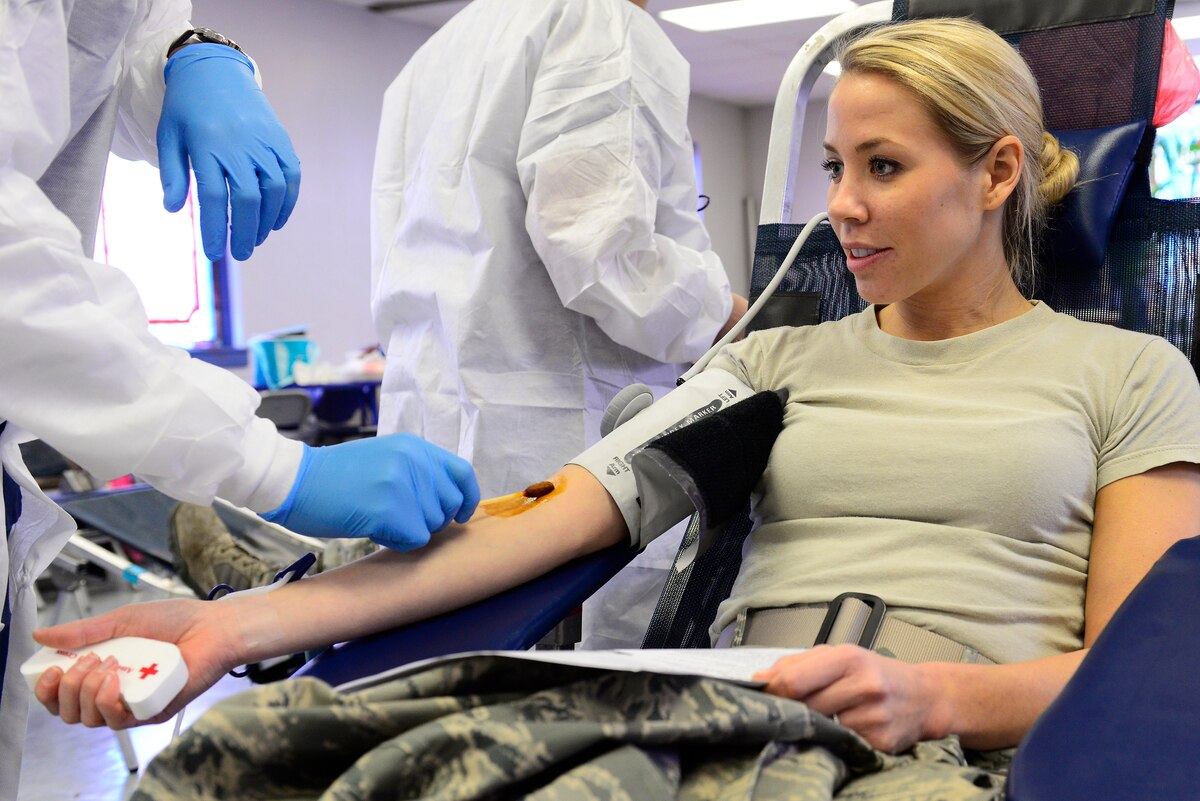 U.S. Air Force Capt. Michelle Tartaglia, 20th Dental Squadron general dentist, is prepped to donate blood at the Palmetto Chapel at Shaw Air Force Base, S.C., Dec. 8, 2014. Donors are encouraged to hydrate before donating blood. It takes approximately eight to 10 minutes to donate a pint of blood. (U.S. Air Force photo by Airman 1st Class Diana M. Cossaboom/Released)