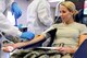 U.S. Air Force Capt. Michelle Tartaglia, 20th Dental Squadron general dentist, is prepped to donate blood at the Palmetto Chapel at Shaw Air Force Base, S.C., Dec. 8, 2014. Donors are encouraged to hydrate before donating blood. It takes approximately eight to 10 minutes to donate a pint of blood. (U.S. Air Force photo by Airman 1st Class Diana M. Cossaboom/Released)