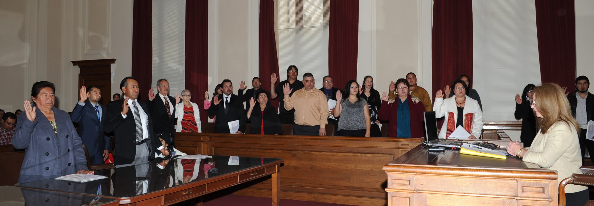 SAN ANGELO, Texas -- Applicants take the oath of allegiance during a naturalization ceremony in the O. C. Fisher Federal Building Dec. 3. Chief Master Sgt. Thomas F. Good, 17th Training Wing Command Chief, was the featured speaker at the event where 37 applicants hailing from Canada, China, Cuba, Jordan, Nepal and Mexico became U.S. citizens. (U.S. Air Force photo/ Staff Sgt. Laura R. McFarlane)