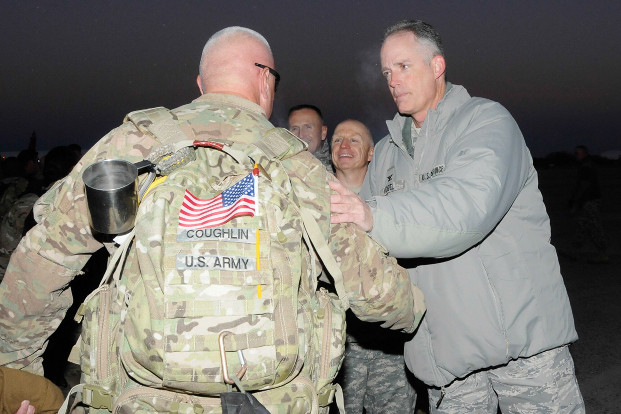 Col. Michael A. Vogel, 66th Air Base Group commander, welcomes home a returning deployer from the 379th Engineer Company, Massachusetts National Guard at the Hanscom flight line Dec. 5, 2014.  Massachusetts Governor Deval Patrick was also on hand for the plane-side ceremony.  Approximately 160 soldiers from the 379th Engineer Company, Massachusetts National Guard, deployed to Afghanistan for approximately nine months in support of Operation Enduring Freedom. (U.S. Air Force photo by Linda LaBonte Britt)