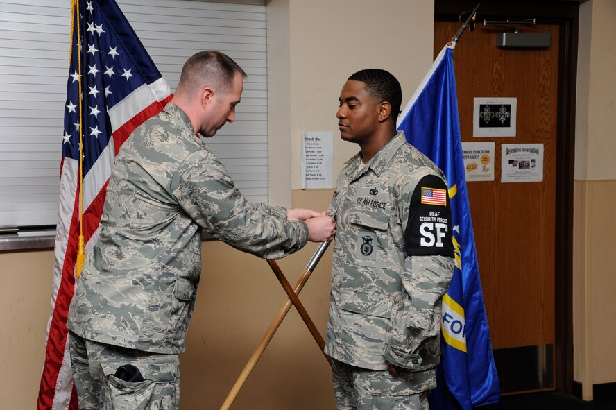 Maj. David Watts, 2nd Security Forces Squadron commander, presents Staff Sgt. James Bryant III, 2nd SFS shift supervisor, with an Air Force Achievement Medal on Barksdale Air Force Base, La., Aug. 1. Bryant saved an airman who was having a seizure, from driving onto a busy cross-section. (U.S. Air Force photo/Senior Airman Kristin High)