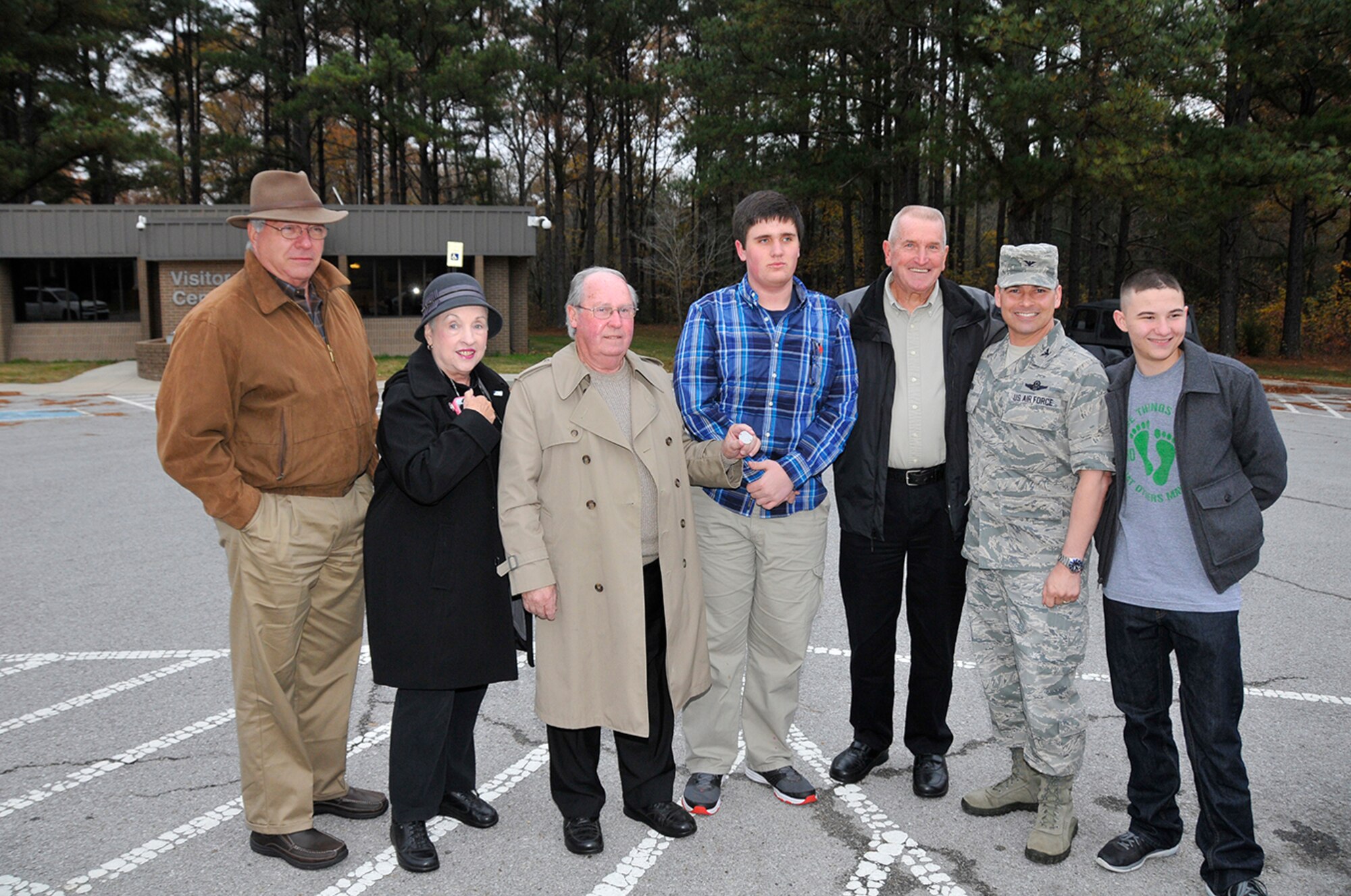 A number of people came together to assist in locating the family of a found dog tag, belonging to Felix Edwin Gore. In addition to Donovan King, AEDC Commander Col. Raymond Toth and his family and the AEDC Woman’s Club were involved in its return. Pictured posing with the dog tag are Bennie Mills; Jane Osgerby; Kenneth Gore, Felix’s son; Donovan King; Clyde Gore, Felix’s son; AEDC Commander Col. Raymond Toth and Daniel Toth. (Photo by Rick Goodfriend)