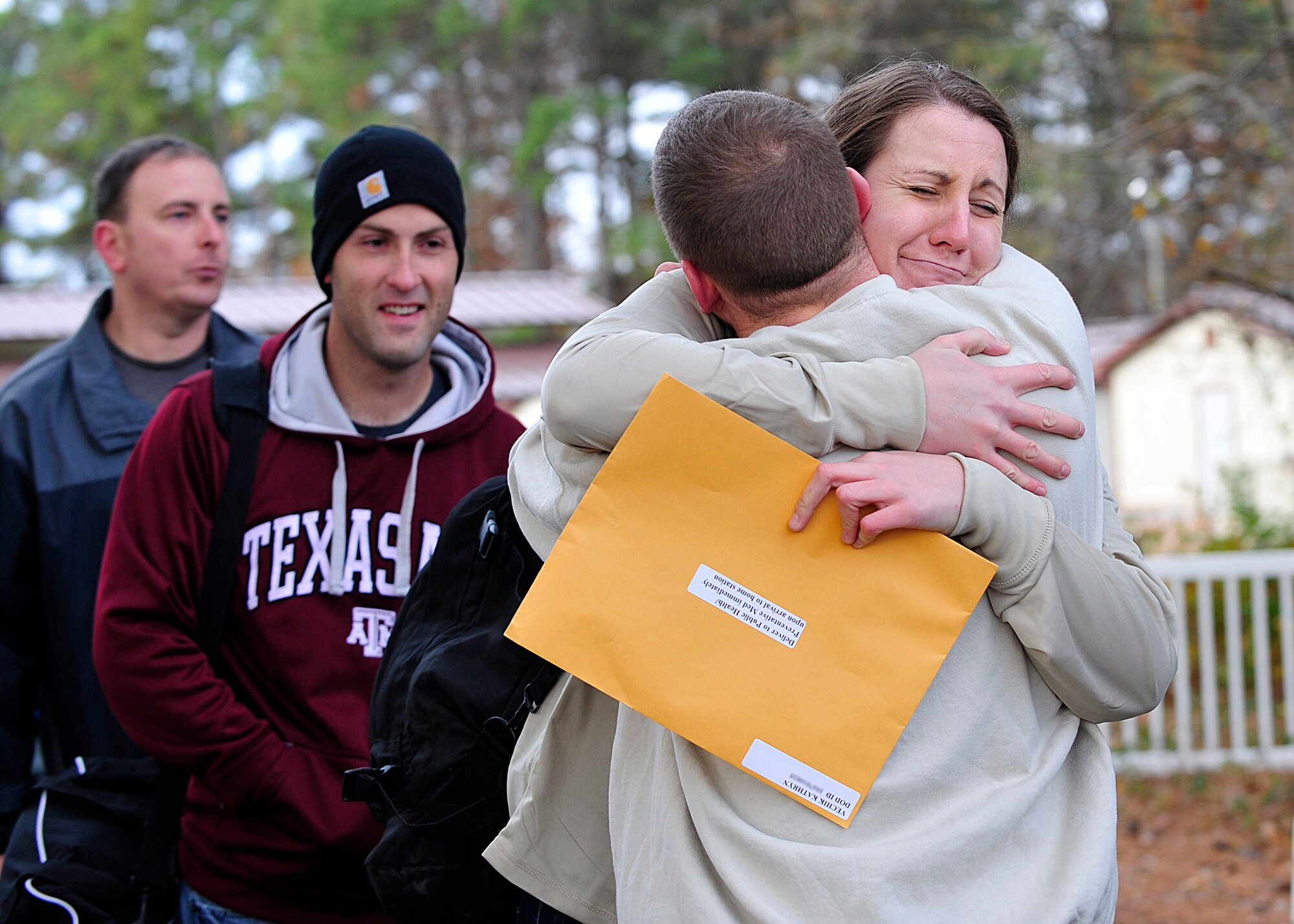 U.S. Service members embrace as they say goodbye to each other outside the Langley Transit Center at Langley Air Force Base, Va., Dec. 4, 2014. While at the LTC, Service members had access to a cafeteria, and entertainment, recreation, and fitness centers. (U.S. Air Force photo by Airman 1st Class Breonna Veal/ Released) 