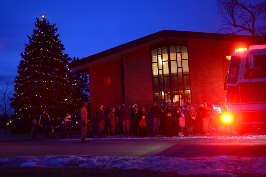 Airmen and families gathered for the 28th Bomb Wing Tree Lighting Ceremony at the Freedom Chapel on Ellsworth Air Force Base, S.D., Dec. 3, 2014. The ceremony included remarks from Col. Kevin Kennedy, 28th BW commander, carolers, holiday goodies, and a visit from Santa Claus. (U.S. Air Force photo by Senior Airman Zachary Hada/Released)