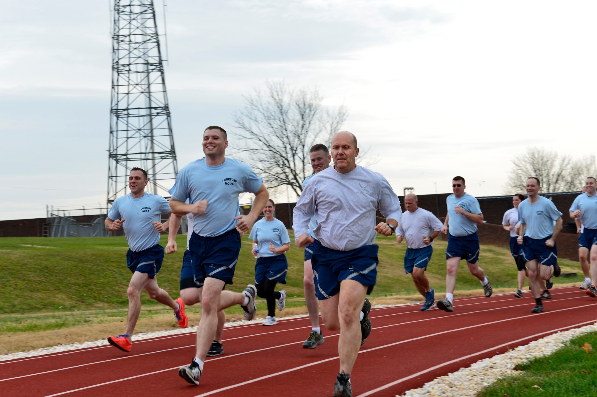 MCGHEE TYSON AIR NATIONAL GUARD BASE, Tenn. - Chaplain Lt. Col. Bruce Brewer, front, joins U.S. Air Force NCO Academy students here Dec. 5, 2014, during a fitness session on the I.G. Brown Training and Education Center's running track. Brewer is assigned as lead chaplain for the 151st Air Refueling Wing, Utah Air National Guard. He served as TEC's interim Chaplain from July to December.  (U.S. Air National Guard photo by Master Sgt. Mike R. Smith/Released) 