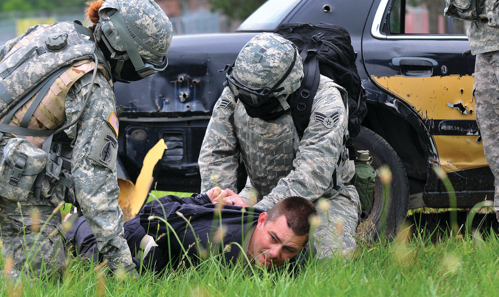 BUTLERVILLE, Ind. - Staff Sgt. Steven Flowers (on the ground), 445th Aerospace Medicine Squadron, is captured by American forces as he portrays an enemy combatant who blew up a gas pipeline in a fictitious eastern European country during a U.S. Army urban warfare exercise. Senior Airmen Michael Bell, 445 AMDS, cuffs Flowers during the training scenario. (U.S. Air Force photo/Tech. Sgt. Frank Oliver)