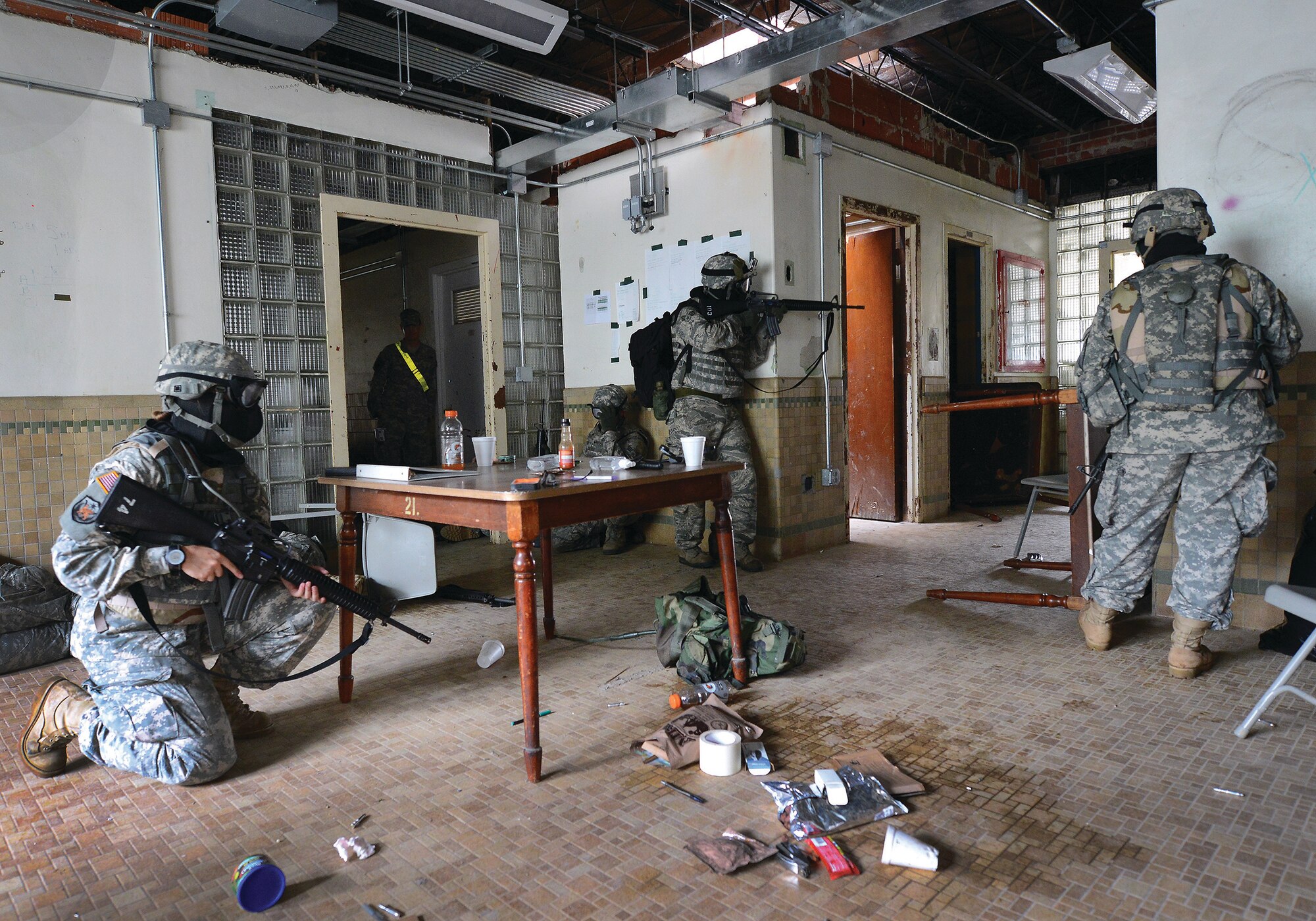 BUTLERVILLE, Ind. – Senior Airman Michael Bell, 445th Aerospace Medicine Squadron, (center), and Army soldiers defend a building during a simulated attack by opposing forces while participating in an Army Reserve exercise held at Muscatatuck Urban Training Complex in southern Indiana June 10-11, 2014. The intense combat training was highlighted during this final battle featuring simulated M16 rifle rounds, smoke and flash-bang grenades, and simulated improvised explosive devices. (U.S. Air Force photo/Tech. Sgt. Frank Oliver)