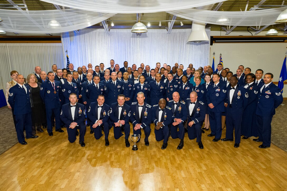 Members of the 333rd Recruiting Squadron pose with the Air Force Recruiting Service top squadron trophy at Patrick AFB, Fla., Nov. 18, 2014. Brig. Gen. James Johnson, Air Force Recruiting Service commander, spoke at the evening banquet and presented the coveted award signifying the best recruiting squadron in the U.S. Air Force, for the second year in a row. The 333rd’s mission is to inspire, engage and recruit the brightest, most competitive and diverse men and women for service in America's Air Force. (U.S. Air Force photo/Cory Long)