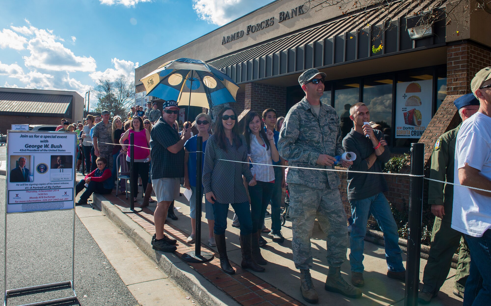Team Moody members wait in line to get books autographed by the Honorable George W. Bush Dec. 4, 2014, at Moody Air Force Base, Ga. More than 800 Department of Defense ID cardholders gathered at the Base Exchange to shake hands with the former U.S. president. (U.S. Air Force photo by Airman 1st Class Ceaira Tinsley/Released)