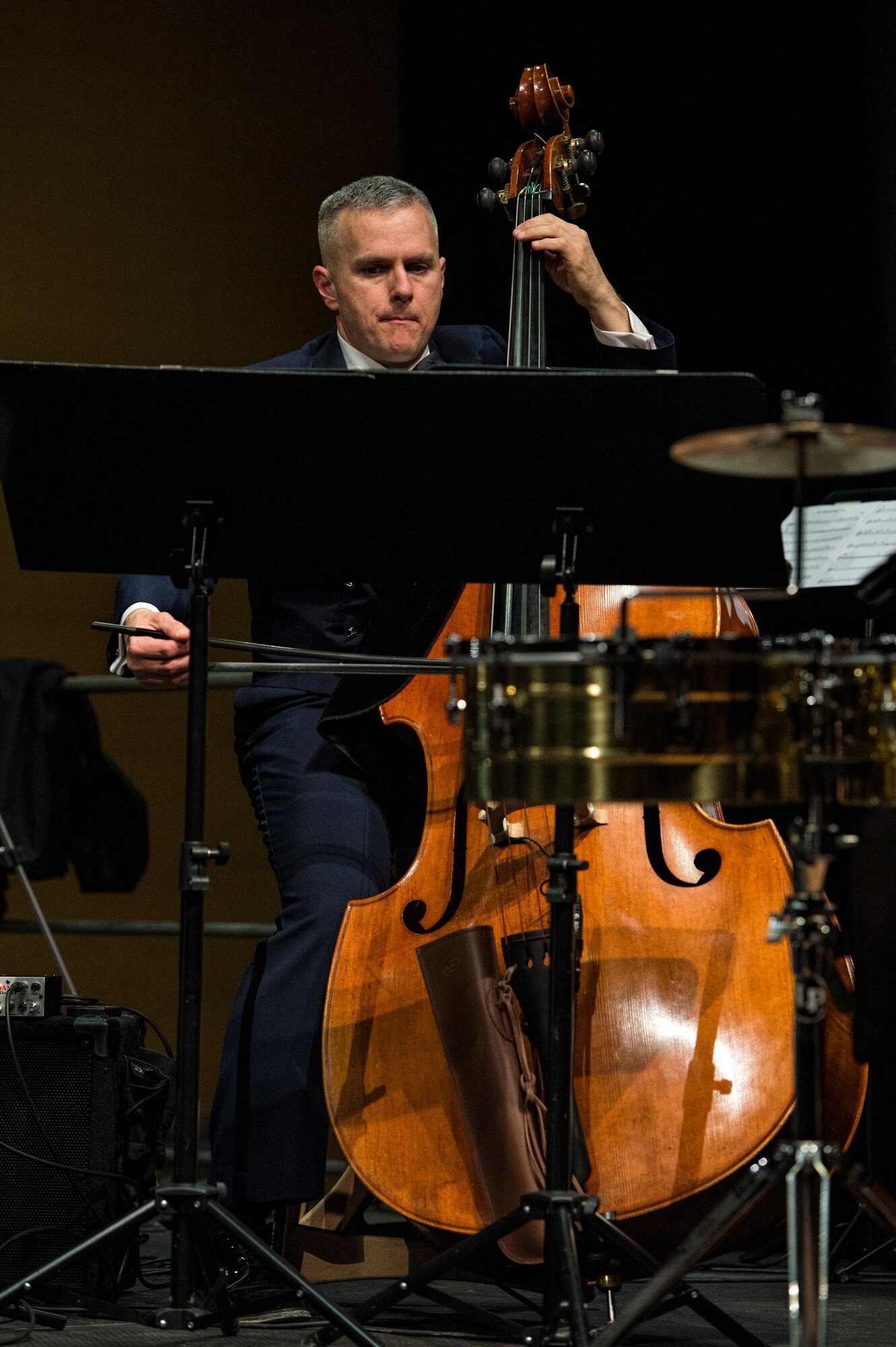 U.S. Air Force Staff Sgt. Joseph Whitt, U.S. Air Forces in Europe Band string bassist from Philadelphia, plays the string bass during a holiday concert in Bitburg, Germany, Dec. 6, 2014. The USAFE Band, stationed at Ramstein Air Base, Germany, holds their holiday concert series in a wide variety of venues across Europe. (U.S. Air Force photo by Staff Sgt. Christopher Ruano/Released)
