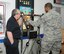 U.S. Air Force Staff Sgt. Micaiah Anthony, right, 100th Air Refueling Wing Public Affairs NCO in charge of External Operations from Baker, Fla., takes part in a Batak board reaction tester as David Daw, Suffolk County Council Road Safety officer, observes Dec. 2, 2014, on RAF Mildenhall, England. During the test, Daw asked Anthony questions while he pushed the pads to simulate a hands-free call. Typical results showed that reaction times are far slower in this situation, demonstrating how even using hands-free can impair a road users ability to react to their surroundings. (U.S. Air Force photo by Gina Randall/Released)