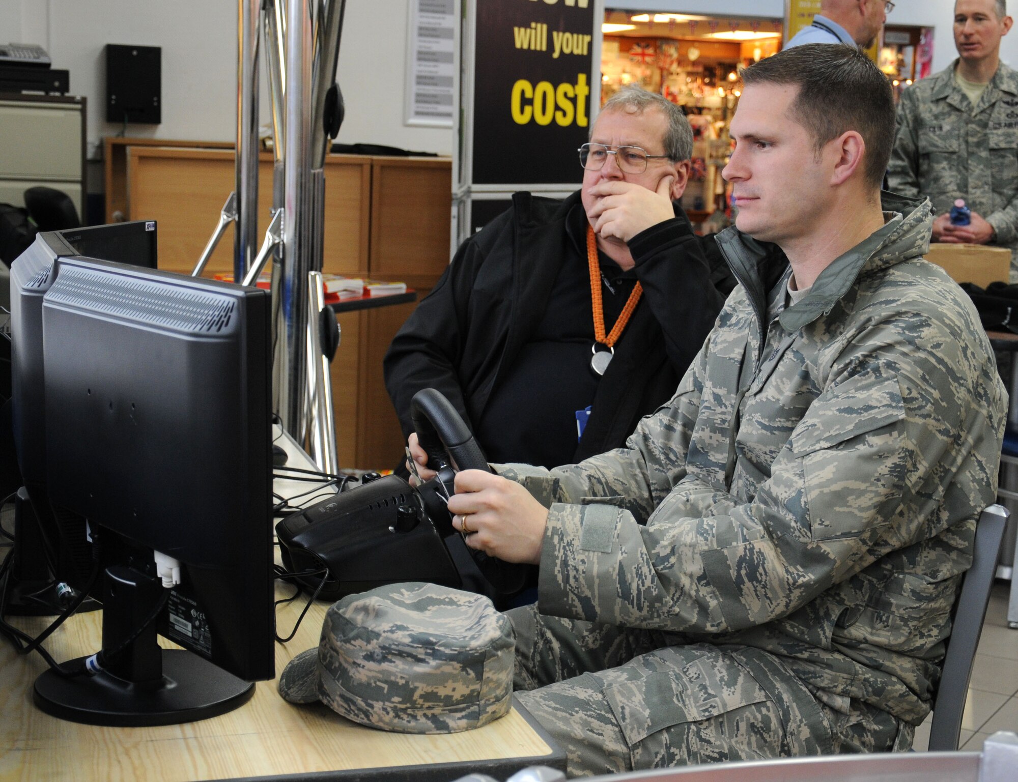 U.S. Air Force Staff Sgt. Koert Lyman, right, 100th Air Refueling Wing Ground Safety technician from Eastham, Mass., takes part in a simulated driver-reaction test prior to David Daw, Suffolk County Council Road Safety officer, giving him feedback on his reaction times Dec. 2, 2014, on RAF Mildenhall, England. The 100th ARW Safety Office invited Suffolk County Council to help educate Team Mildenhall on the dangers facing them as they drive on the local roads. (U.S. Air Force photo by Gina Randall/Released)