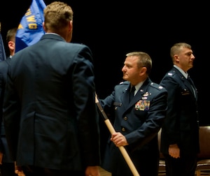 JOINT BASE ELMENDORF-RICHARDSON, Alaska -- Lt.Col. Michael Griesbaum accepts the 176th Maintenance Group flag signifying his new position as commander during a ceremony here Dec. 6, 2014. U.S. Air National Guard photo by Staff Sgt N. Alicia Halla/ Released