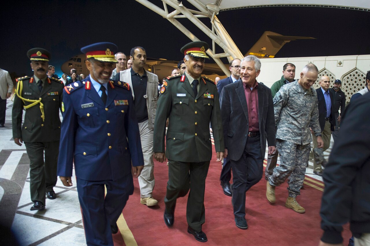 Defense Secretary Chuck Hagel, center right, walks with Kuwaiti Army Chief of Staff Lt. Gen. Mohammad al-Khoder as he arrives at the Kuwait International Airport, Kuwait, Dec. 7, 2014. DoD photo by Air Force Master Sgt. Adrian Cadiz