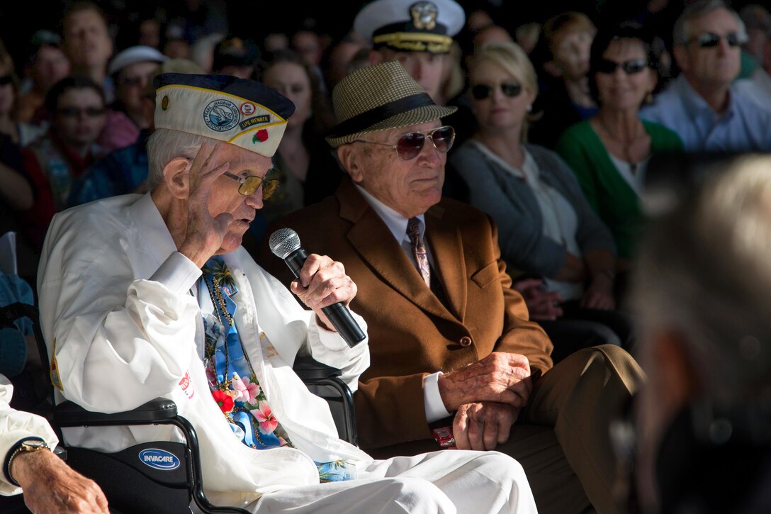 Jack Evans, left, vice president of the Pearl Harbor Survivors Association, Chapter 3, speaks to the audience during a remembrance ceremony for the 73rd anniversary of the attack on Pearl Harbor aboard the USS Midway Museum in San Diego, Dec. 7, 2014. The annual ceremony honored the 2,403 Americans lost during the Dec. 7, 1941, Japanese attack on Pearl Harbor.