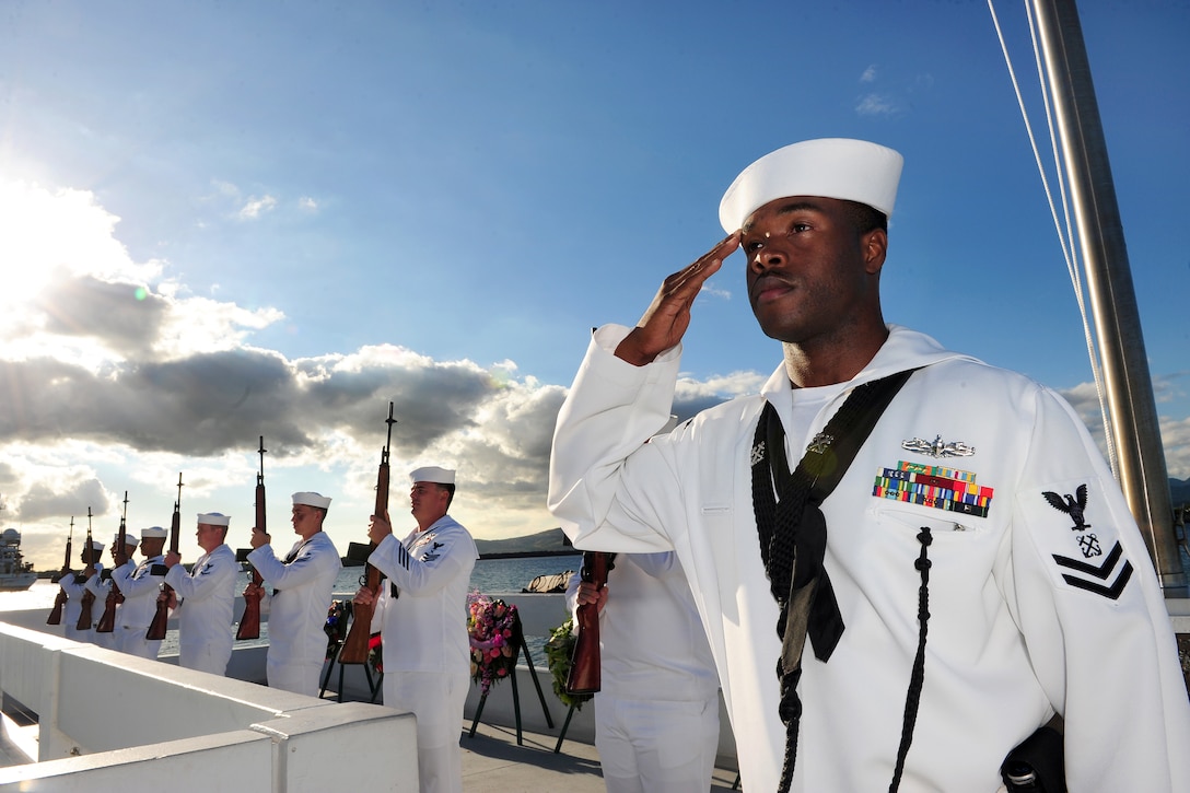 Navy Petty Officer 2nd Class Leland Harris, right, assigned to Joint Base Pearl Harbor-Hickam Honors and Ceremonial Guard, renders a salute during an ash scattering ceremony held in honor of Pearl Harbor attacks survivor Navy Petty Officer 2nd Class Harvey E. Smith at the USS Utah Memorial on Pearl Harbor, Hawaii, Dec. 7, 2014.