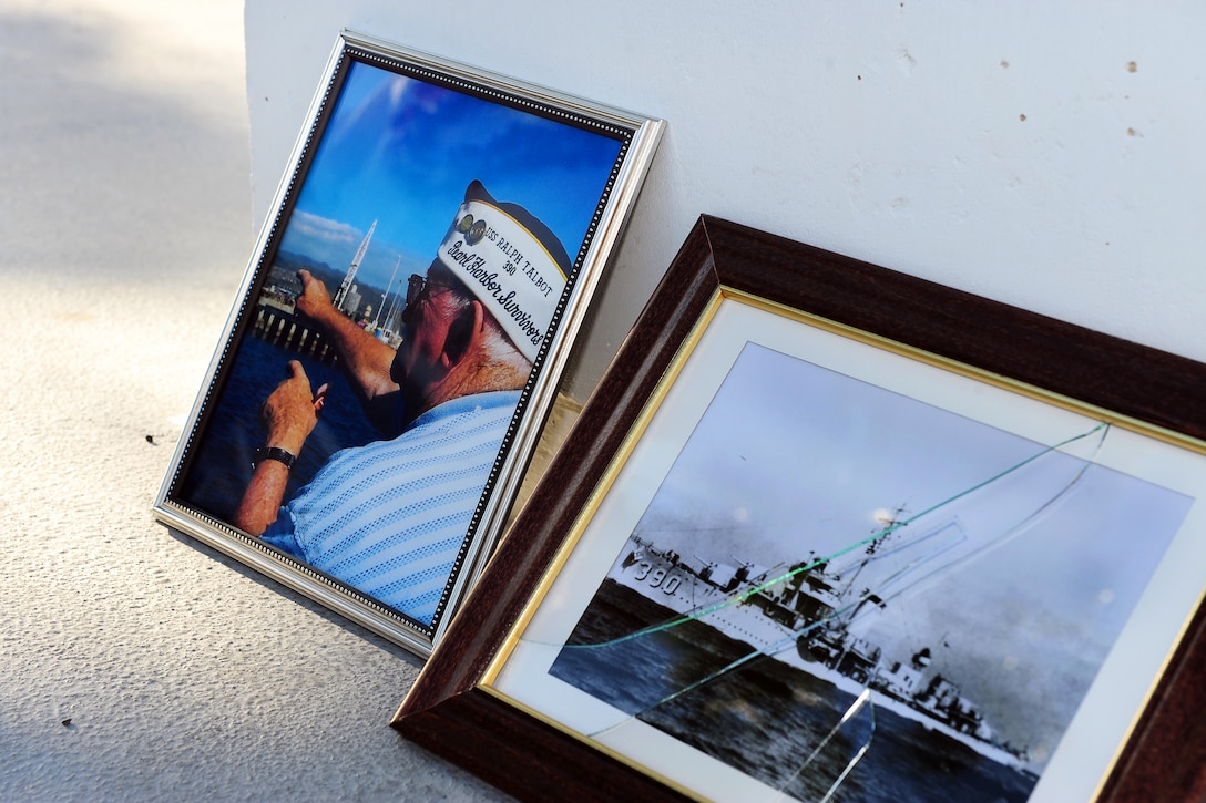 Photographs of Pearl Harbor attacks survivor Navy Petty Officer 2nd Class Harvey E. Smith, and of the USS Ralph Talbot, rest at the USS Utah Memorial on Pearl Harbor, Dec. 7, 2014, during an ash scattering ceremony held in his honor. Smith was serving aboard Talbot during the Dec. 7, 1941, Japanese attacks on Pearl Harbor.