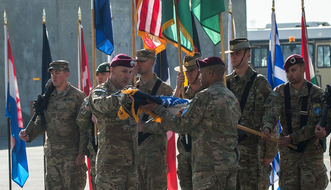 U.S. Army Lt. Gen. Joseph Anderson, commander of International Security Assistance Force Joint Command, and Command Sgt. Maj. Isaia T. Vimoto, ISAF Command sergeant major, case the U.S. Army XVIII Airborne Corps colors during the command's end-of-mission ceremony on North Kabul International Airport in Afghanistan, Dec. 8, 2014.