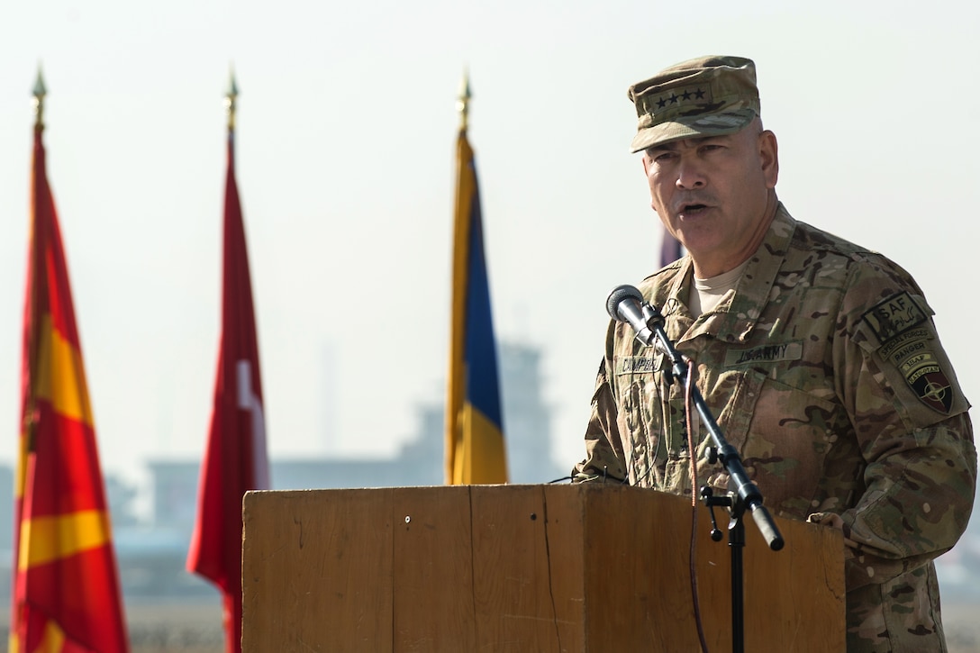 U.S. Army Gen. John F. Campbell, commander of International Security Assistance Force, delivers remarks during the ISAF Joint Command and U.S. Army XVIII Airborne Corps end-of-mission ceremony on North Kabul International Airport in Afghanistan, Dec. 8, 2014. 
