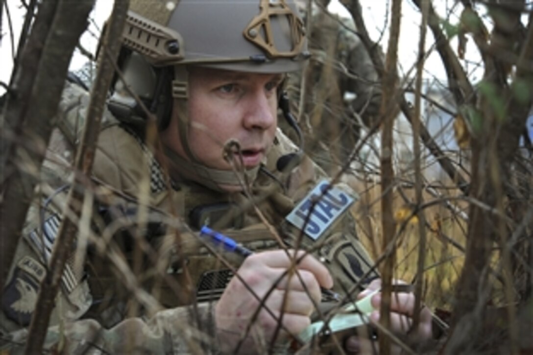 U.S. Air Force Tech. Sgt. Andrew Carpenter writes down coordinates during Joint Terminal Attack Controller training in Barcis, Italy, Dec. 2, 2014. Carpenter is assigned to 2nd Air Support Operations Squadron.