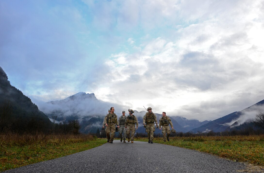 Air Force joint terminal attack controllers and Army joint fire observers walk back from a training exercise Dec. 2, 2014, in Barcis, Italy. The JTACs are from the 2nd Air Support Operations Squadron and the fire observers are from the 503rd Infantry Regiment. During a week-long exercise near Aviano Air Base, Italy, JTACs coordinated with F-16 Fighting Falcons and practiced calling in airstrikes on simulated targets in the mountains. (U.S. Air Force photo/Senior Airman Matthew Lotz)
