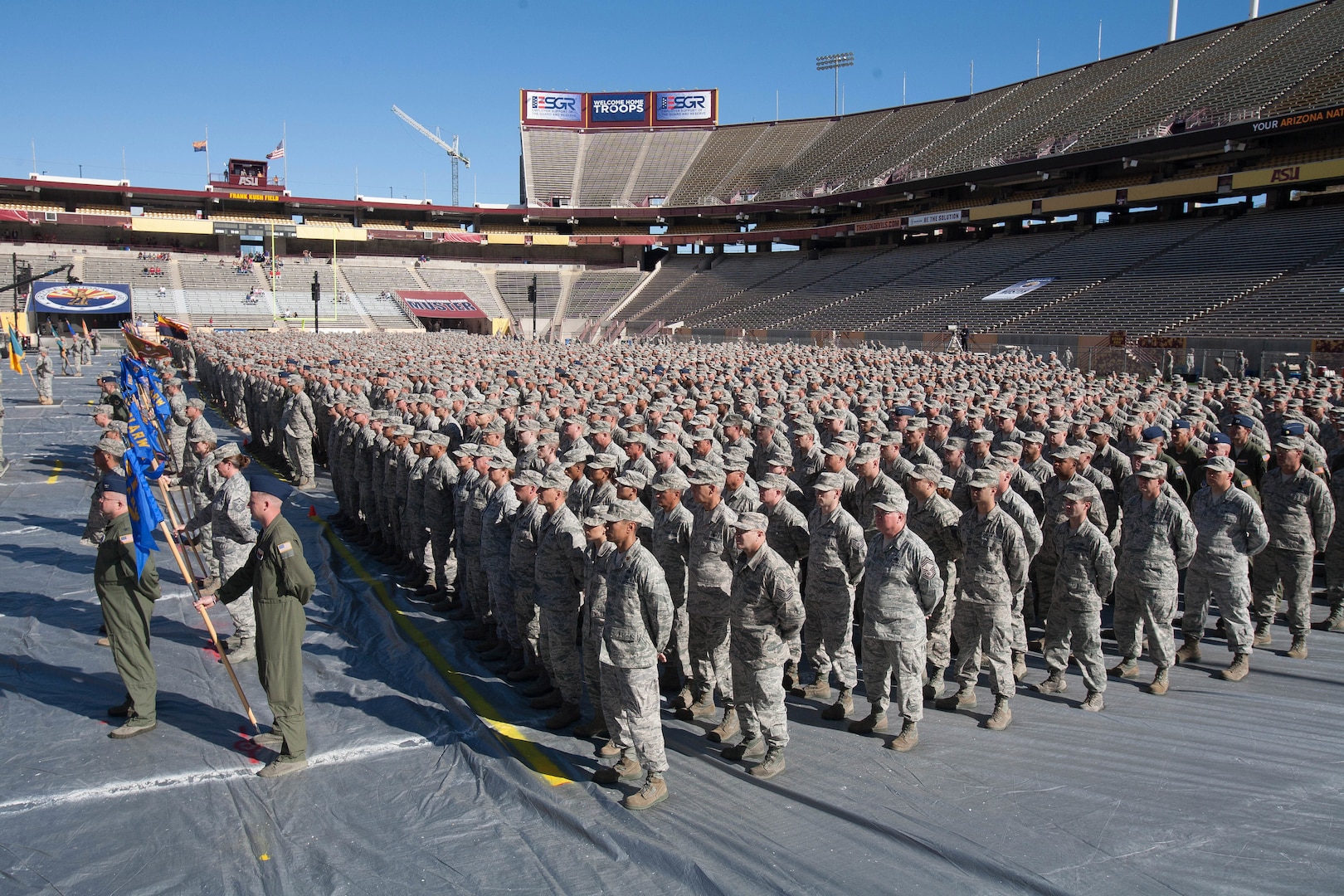 Arizona National Guard Soldiers from the 158th Maneuver Enhancement Brigade stand in formation on the field at Arizona State University’s Sun Devil Stadium, Dec. 7, 2014 in Tempe.  The formation, which was part of the Arizona National Guard Muster and Community Expo, was the first time in over a century Arizona Soldiers and Airmen assembled together in mass formation.