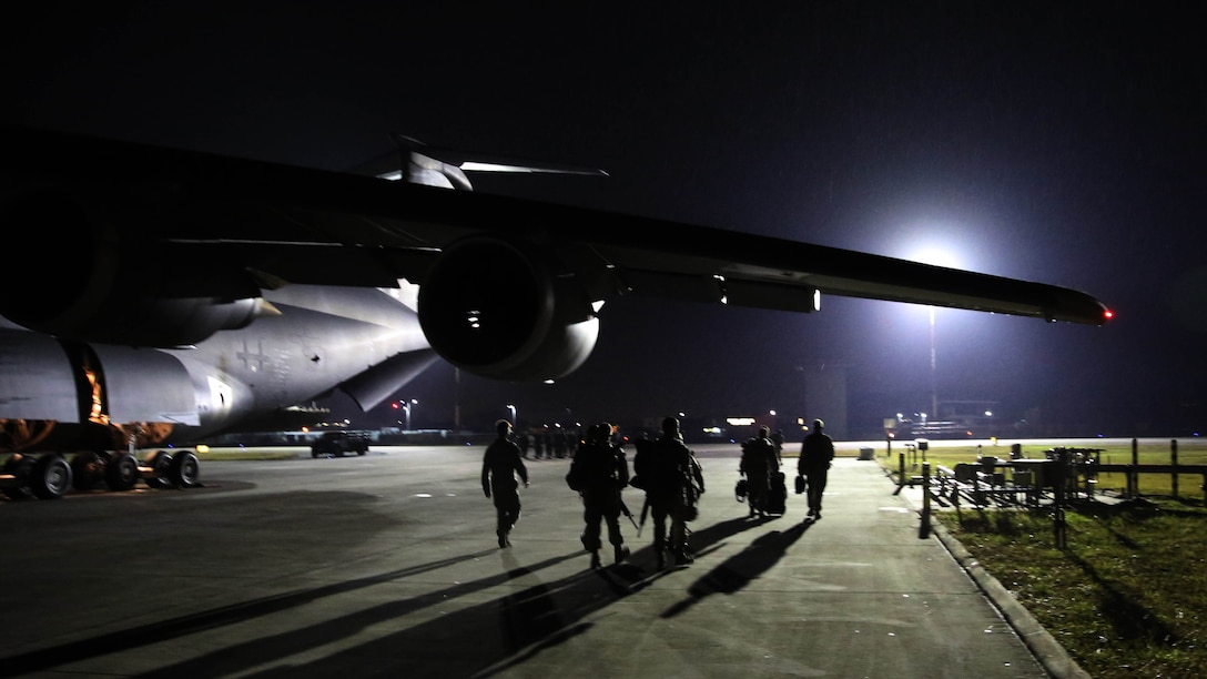The final nine 2nd Marine Aircraft Wing Marines to serve in Afghanistan walk down the flight line at Marine Corps Air Station Cherry Point, N.C., Dec. 6. 2014. The Marines belong to Marine Light Attack Helicopter Squadron 467 stationed at Marine Corps Air Station New River, N.C., and served more than seven months in Afghanistan.