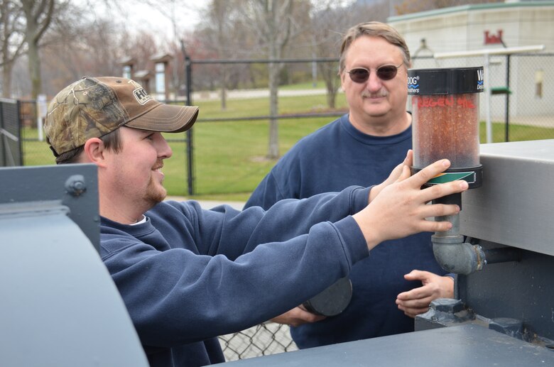 MINNESOTA CITY, Minn. -- Nathan Van Loon, operations, and Duane Skjeie, operations, change a filter at Lock and Dam 5, near Minnesota City, Minn., Nov. 5.  