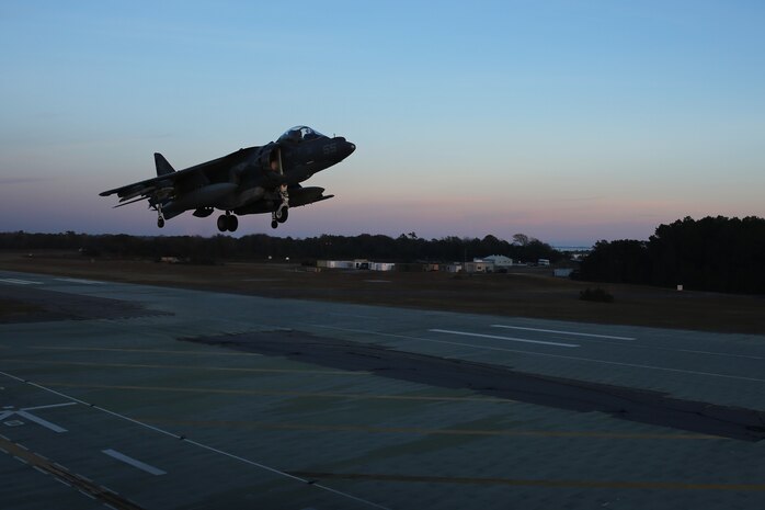 An AV-8B Harrier hovers during field carrier landing practice sustainment training at Marine Corps Auxiliary Landing Field Bogue, N.C., Dec. 5, 2014. Marines with Marine Attack Squadron 231 honed their skills in preparation for an upcoming deployment with the 24th Marine Expeditionary Unit.