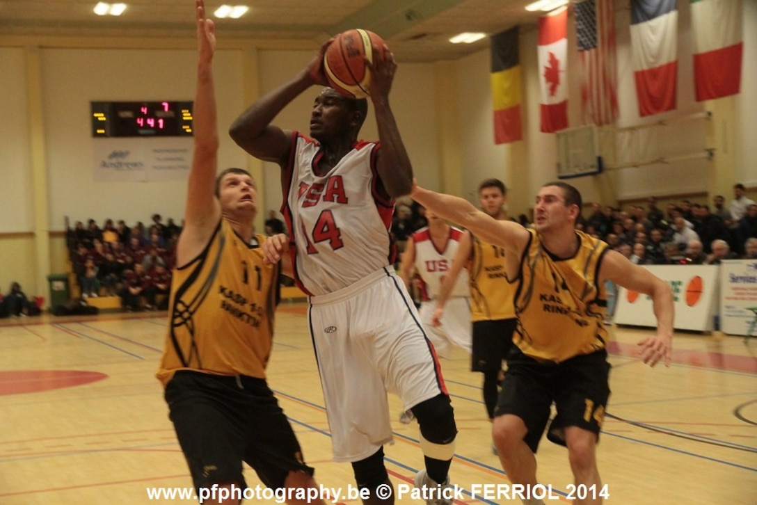 Air Force 2nd lt. Mike Lyons of Peterson Air Force Base, Colo., drives in for the lay-up during USA's victory over Lithuania 87-82 at the SHAPE International Basketball Championship Dec. 1-6 2014.