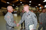 Command Sgt. Maj. Rafael Conde, senior enlisted advisor for the 32nd Infantry Brigade Combat  Team, congratulates Sgt. Michael Black of Brookfield, Wisconsin, a combat medic assigned to Headquarters Company, 2nd Battalion, 127th Infantry Regiment in Appleton, Wis. Black received the Soldier's Medal Dec. 7, 2014, for his actions on Jan. 5, 2013 that saved a woman's life near White Sands Missile Range, New Mexico. 