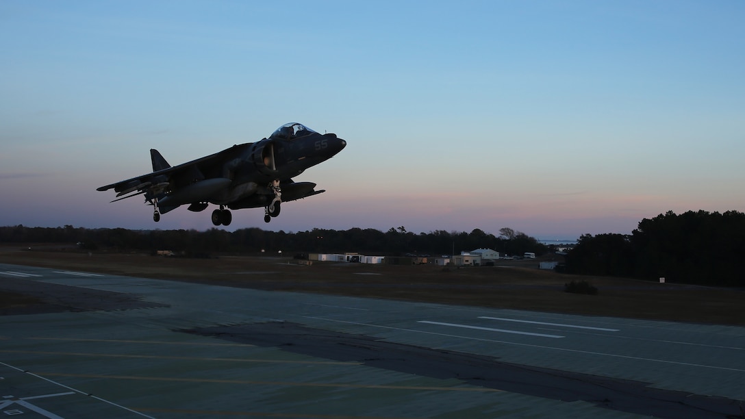 An AV-8B Harrier hovers during field carrier landing practice sustainment training at Marine Corps Auxiliary Landing Field Bogue, N.C., Dec. 5, 2014. Marines with Marine Attack Squadron 231 honed their skills in preparation for an upcoming deployment with the 24th Marine Expeditionary Unit.