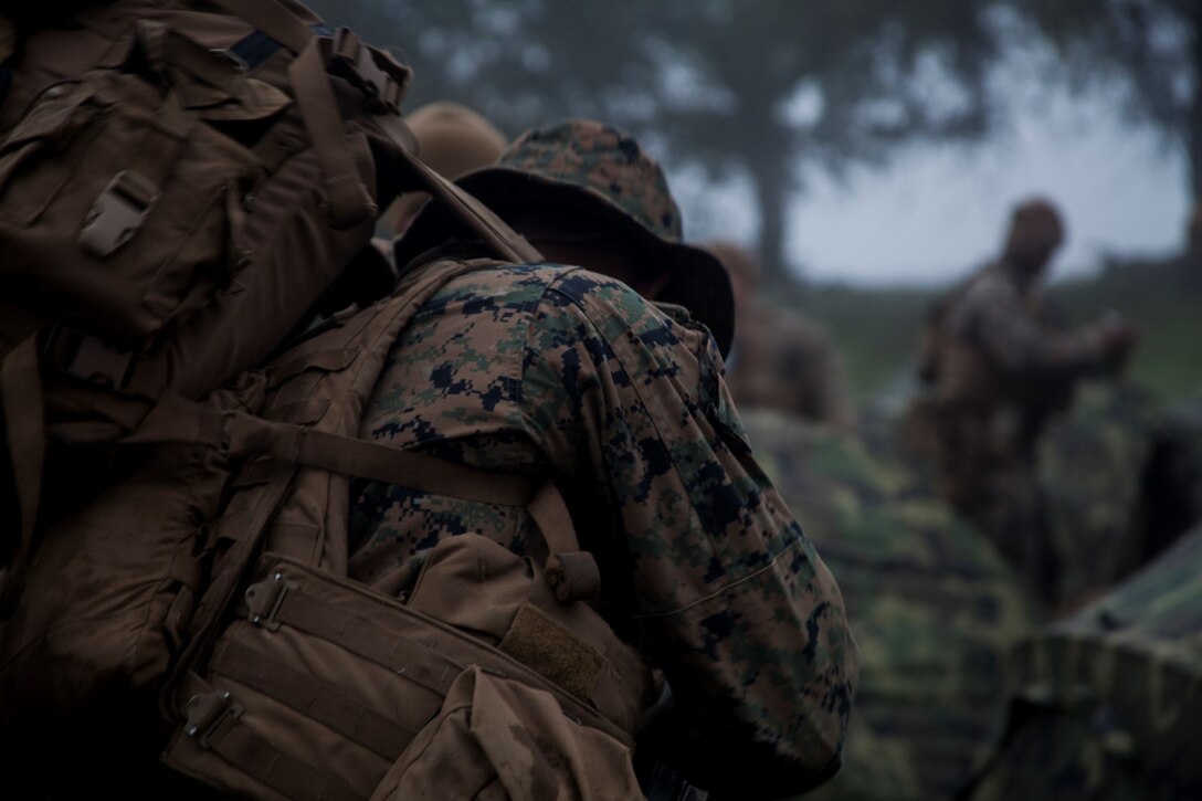 Marines with Lima Company, 3rd Battalion, 1st Marine Regiment, 15th Marine Expeditionary Unit prepare their gear during a realistic urban training exercise aboard Camp Roberts, Calif., Dec. 8, 2014. RUT prepares the 15th MEU Marines for their upcoming deployment, enhancing their combat skills in environments similar to those they may find in future missions. (U.S. Marine Corps photo by Cpl. Elize McKelvey/Released)