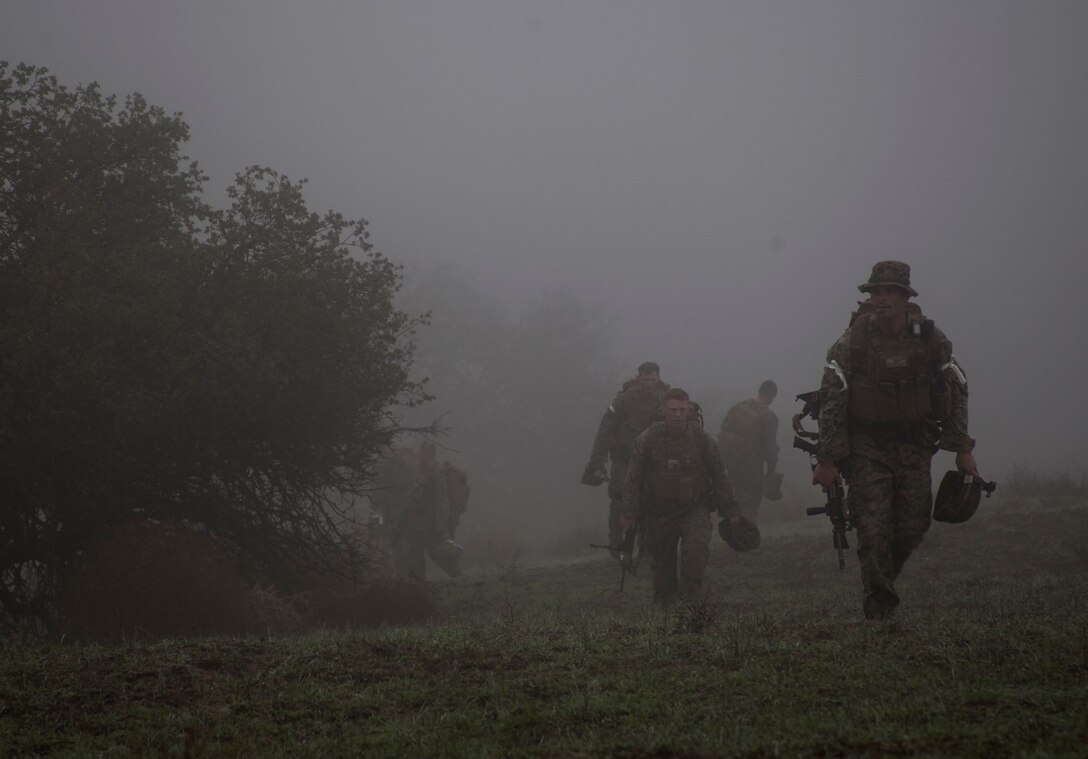 Marines with Lima Company, 3rd Battalion, 1st Marine Regiment, 15th Marine Expeditionary Unit hike to a range during a realistic urban training exercise aboard Camp Roberts, Calif.,  Dec. 8, 2014. RUT prepares the 15th MEU Marines for their upcoming deployment, enhancing their combat skills in environments similar to those they may find in future missions. (U.S. Marine Corps photo by Cpl. Elize McKelvey/Released)