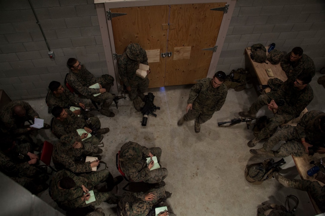 U.S. Marine Lance Cpl. Dominique Sparacino gives a class about assessing a target site to Marines with Lima Company, 3rd Battalion, 1st Marine Regiment, 15th Marine Expeditionary Unit during a realistic urban training exercise aboard Camp Roberts, Calif., Dec. 8, 2014. RUT prepares the 15th MEU Marines for their upcoming deployment, enhancing their combat skills in environments similar to those they may find in future missions. (U.S. Marine Corps photo by Cpl. Elize McKelvey/Released)