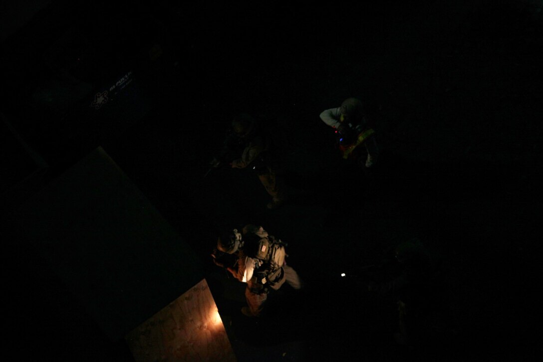 U.S. Marines with the 15th Marine Expeditionary Unit’s Maritime Raid Force prepare to breach a door at Dodger Stadium during realistic urban training in Los Angeles Dec. 8, 2014. RUT prepares the 15th MEU Marines for their upcoming deployment, enhancing their combat skills in environments similar to those they may find in future missions. (U.S. Marine Corps photo by Staff Sgt. Miguel Carrasco/Released)