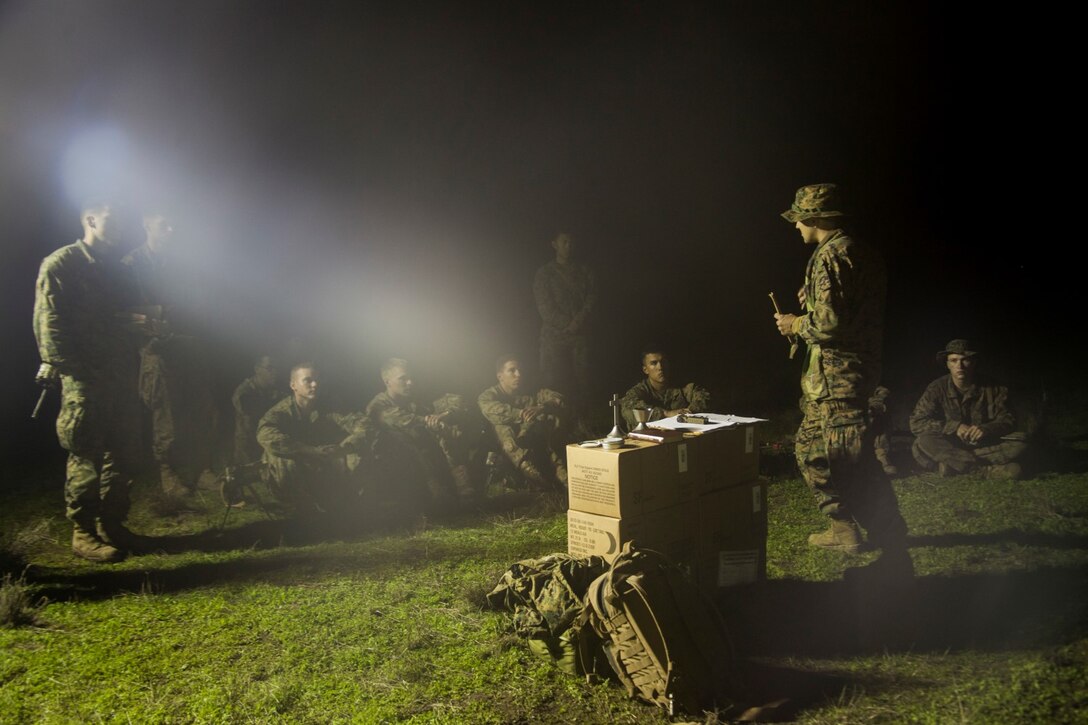 U.S. Navy Lt. Justin Hayes gives a sermon during a realistic urban training exercise aboard Camp Roberts, Calif., Dec. 8, 2014. Hayes is the chaplain for 3rd Battalion, 1st Marine Regiment, 15th Marine Expeditionary Unit. RUT prepares the 15th MEU Marines for their upcoming deployment, enhancing their combat skills in environments similar to those they may find in future missions. (U.S. Marine Corps photo by Cpl. Elize McKelvey/Released)