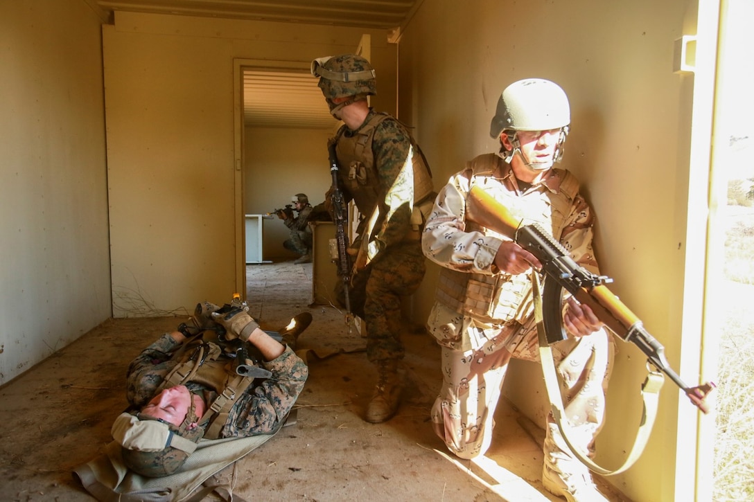 U.S. Marines with Battalion Landing Team 3rd Battalion, 1st Marine Regiment, 15th Marine Expeditionary Unit, and role-players evacuate a simulated casualty while participating in realistic urban training aboard Fort Hunter Liggett, Calif., Dec. 8, 2014. The Marines were simulating bi-lateral training exercises they could be tasked with while deployed. RUT prepares the 15th MEU's Marines for their upcoming deployment, enhancing their combat skills in environments similar to those they may find in future missions. (U.S. Marine Corps Photo by Sgt. Jamean Berry/Released)