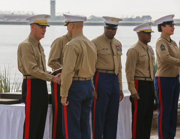 General Joseph F. Dunford, 36th Commandant of the Marine Corps, hands out awards to the recruiting station leaders during the Superior Achiever Award Ceremony at the Admiral Kidd Conference Center, Naval Base Point Loma, San Diego, Dec. 5.  One of the most important jobs in the Marine Corps is finding new Marines.  The men and women tasked with this job are responsible of creating the future of the Corps
