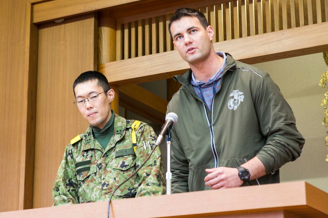 U.S. Marine Staff Sgt. Ryan T. Watson speaks to students Dec. 5 at Chinzei High School in Kumamoto prefecture, Japan. Marines participating in Forest Light 15-1 took a day off from training to visit local high schools to exchange culture lessons with the students. Forest Light is a routine, semi-annual exercise designed to enhance the U.S. and Japan military partnership, solidify regional security agreements, and improve individual and unit-level skills in a bilateral training environment. Watson, from Tulsa, Oklahoma, is an infantry unit leader with 2nd Battalion, 9th Marine Regiment, currently assigned to 4th Marine Regiment, 3rd Marine Division, III Marine Expeditionary Force, under the unit deployment program. 