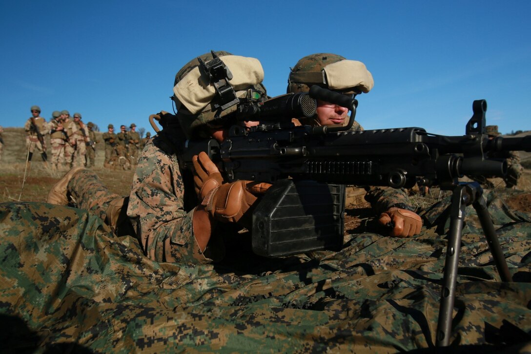 U.S. Marine Corps Lance Cpl. Joseph Monrreal and Lance Cpl. Samuel Hussman with Battalion Landing Team 3rd Battalion, 1st Marine Regiment, 15th Marine Expeditionary Unit, demonstrate a security position while participating in realistic urban training aboard Fort Hunter Liggett, Calif., Dec. 8, 2014. The Marines were simulating bi-lateral training exercises they could be tasked with while deployed. RUT prepares the 15th MEU's Marines for their upcoming deployment, enhancing their combat skills in environments similar to those they may find in future missions. (U.S. Marine Corps Photo by Sgt. Jamean Berry/Released)