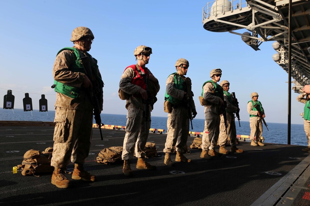 Marines with Combat Logistics Battalion 11, 11th Marine Expeditionary Unit (MEU), participate in a live-fire range aboard the amphibious assault ship USS Makin Island (LHD 8), Dec. 5. The Makin Island Amphibious Ready Group (ARG) and the embarked 11th Marine Expeditionary Unit are deployed in support of maritime security operations and theater security cooperation efforts in the U.S. 5th Fleet area of responsibility. (U.S. Marine Corps photos by Cpl. Demetrius Morgan/Released)