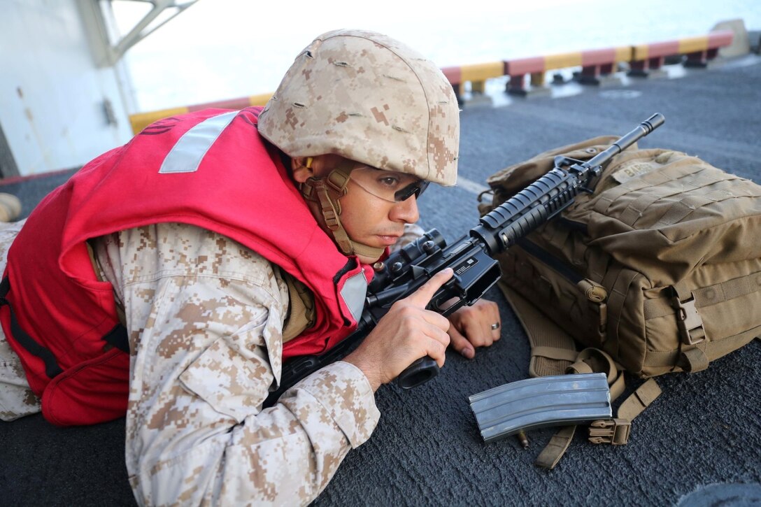 Sgt. Danyel Tactay, a radio repairman with Combat Logistics Battalion 11, 11th Marine Expeditionary Unit (MEU), pauses between relays during a live-fire range aboard the amphibious assault ship USS Makin Island (LHD 8), Dec. 5. The Makin Island Amphibious Ready Group (ARG) and the embarked 11th Marine Expeditionary Unit are deployed in support of maritime security operations and theater security cooperation efforts in the U.S. 5th Fleet area of responsibility. (U.S. Marine Corps photos by Cpl. Demetrius Morgan/Released)