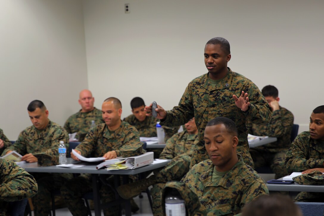 Staff Sgt. Joseph Scott leads a class discussion during an Equal Opportunity Representative Course at Marine Corps Air Station Cherry Point, N.C., Dec. 4, 2014. More than 25 Marines from across the East Coast attended the course to learn the fundamentals of Equal Opportunity. Scott is the equal opportunity advisor for Cherry Point.