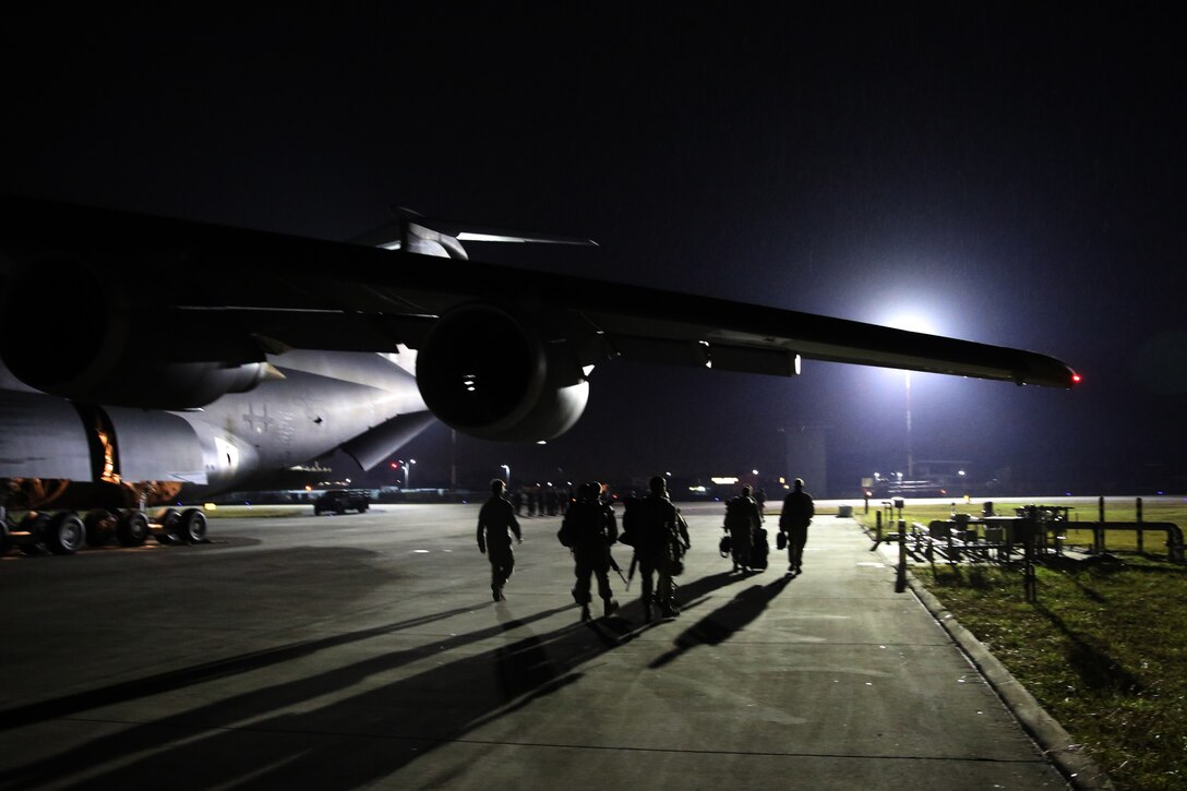 The final nine 2nd Marine Aircraft Wing Marines to serve in Afghanistan walk down the flight line at Marine Corps Air Station Cherry Point, N.C., Dec. 6. 2014. The Marines belong to Marine Light Attack Helicopter Squadron 467 stationed at Marine Corps Air Station New River, N.C., and served more than seven months in Afghanistan.