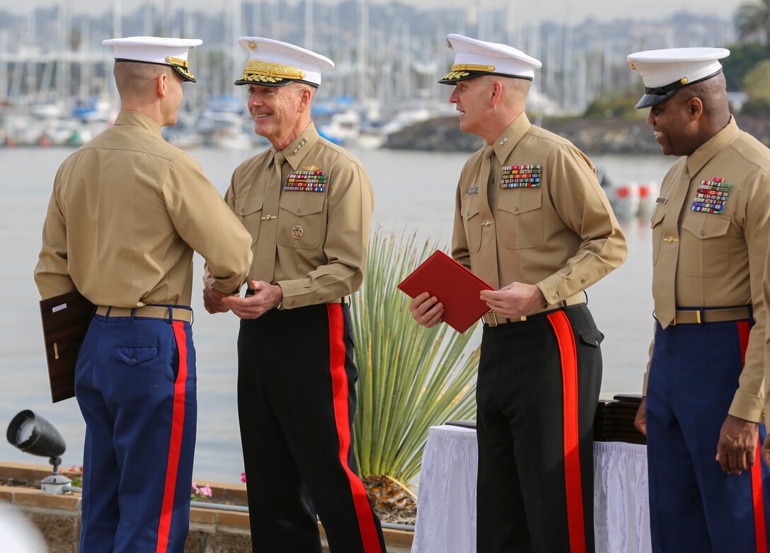 General Joseph F. Dunford, 36th Commandant of the Marine Corps, hands out awards to the recruiting station leaders during the Superior Achiever Award Ceremony at the Admiral Kidd Conference Center, Naval Base Point Loma, San Diego, Dec. 5.  One of the most important jobs in the Marine Corps is finding new Marines.  The men and women tasked with this job are responsible of creating the future of the Corps