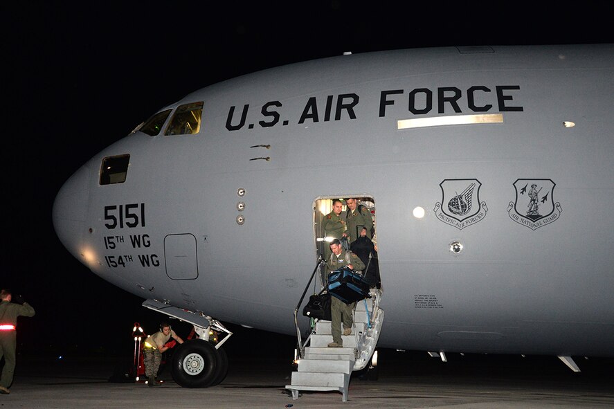The Pacific Air Forces’ joint component coordination element and C-17 Globemaster III aircrew arrive at Andersen Air Force Base, Guam, Dec. 6, 2014. C-17 aircrew and the JACCE demonstrated PACAF’s capability to rapidly deploy in less than 24 hours from Joint Base Pearl Harbor-Hickam, and will continue their training alongside the 36th Wing Contingency Response Group at Andersen Air Force Base, Guam.  