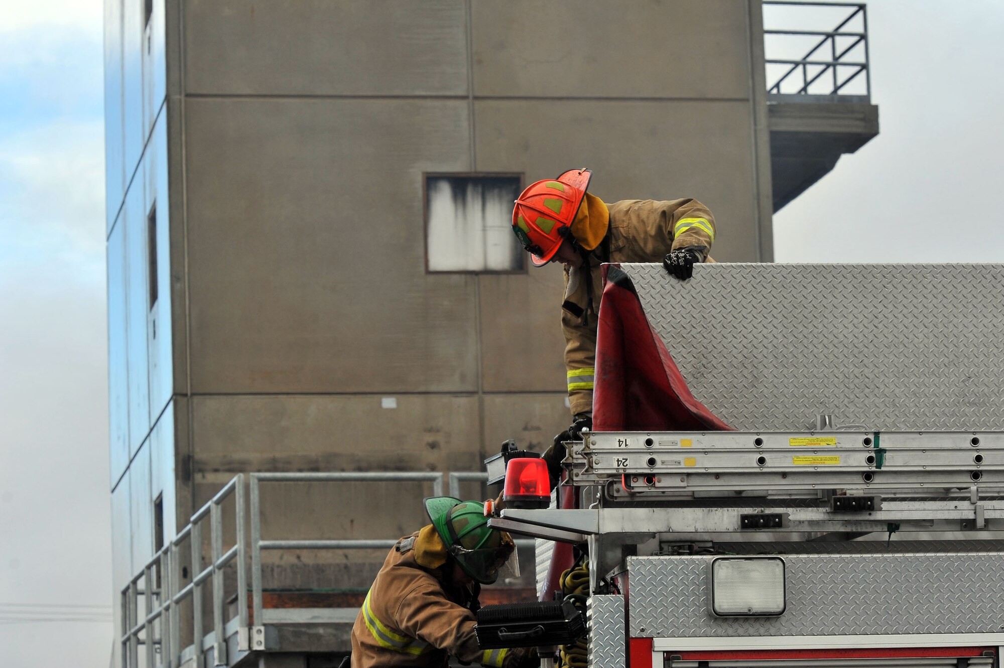 Staff Sgt. Shane Bedard, 336th Training Squadron Survival Evasion Resistance Escape parachute rigger, gets prepared to climb off the truck with recruits from the local community during a multi-company training drill Dec. 6, 2014, in Spokane Valley, Wash. Bedard was one of 23 recruits from the West Plains Fire Academy participating in the drill. (U.S. Air Force photo/Staff Sgt. Veronica Montes)