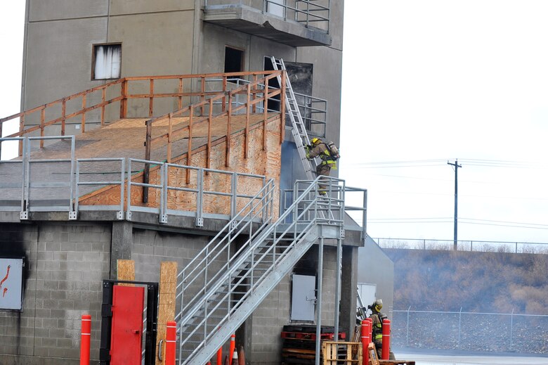 Firefighting recruits from Fairchild Air Force Base, Wash., and the local community enter