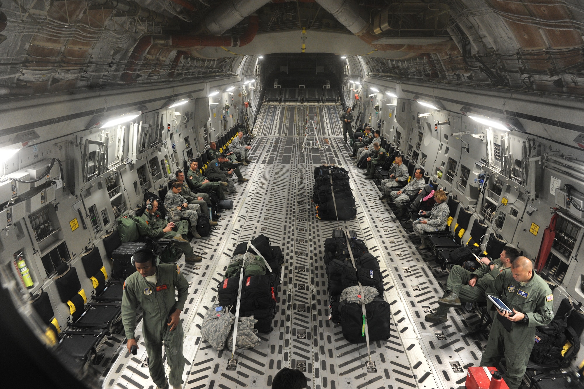The Pacific Air Forces’ joint component coordination element prepare for takeoff on a C-17 Globemaster III from the 535th Airlift Squadron Dec. 5, 2014, at Joint Base Pearl Harbor-Hickam, Hawaii. C-17 aircrew and the JACCE demonstrated PACAF’s capability to rapidly deploy in less than 24 hours, and will continue their training alongside the 36th Wing Contingency Response Group at Andersen Air Force Base, Guam.